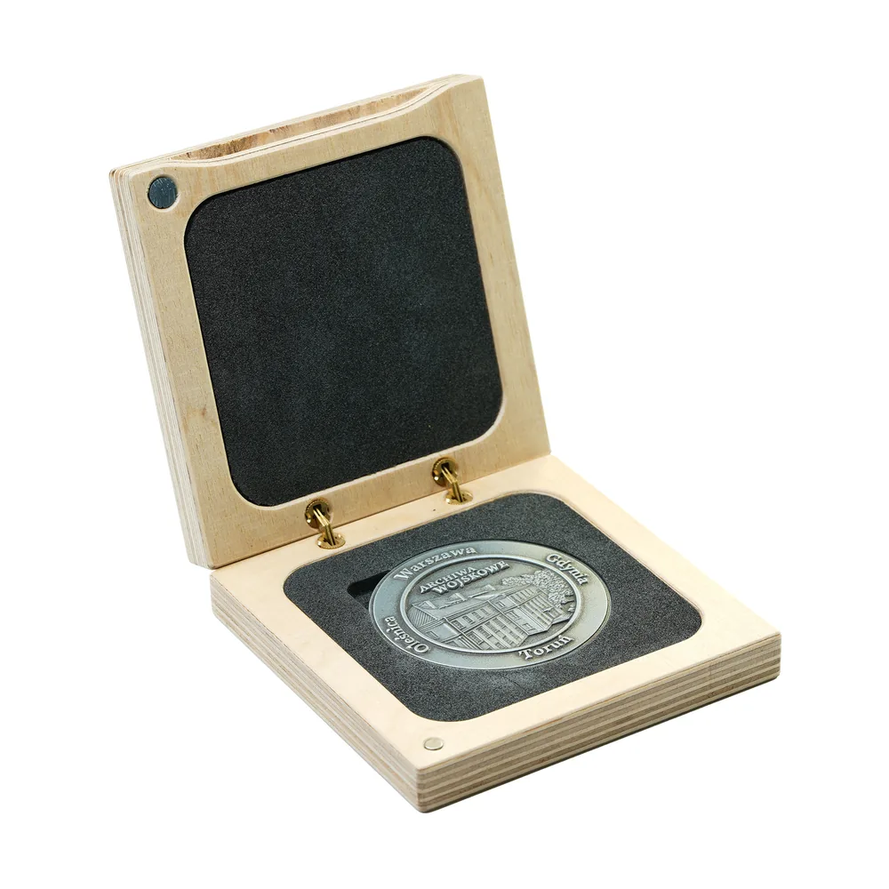 Plywood medal box with a foam insert cut to the shape of the medal